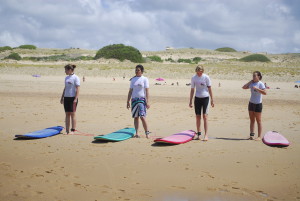girls learning how to surf