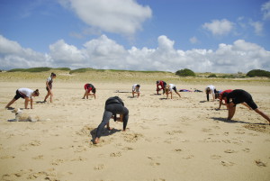 people doing pre surf yoga