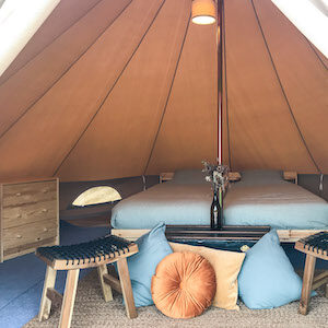 Glamping double bed at Far End Surf House